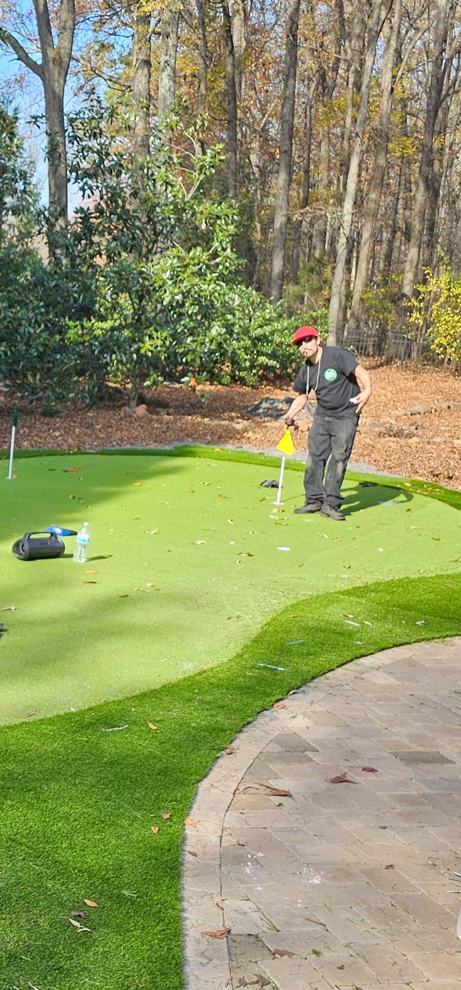 maintenance crew working turf on golf course