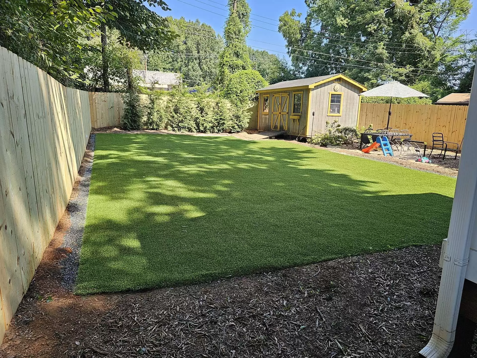 artificial turf backyard by shed
